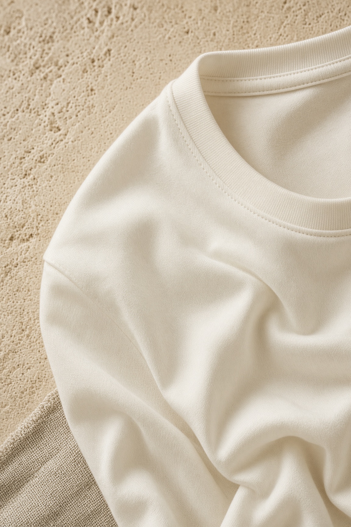 Creative close-up study of a light T-shirt neckline and drape